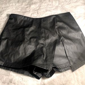 This is a black leather skort